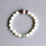 White bodhi seed bracelet with carved flower and jade accents-from above