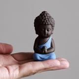 Blue Robe Meditation monk - sitting on hand