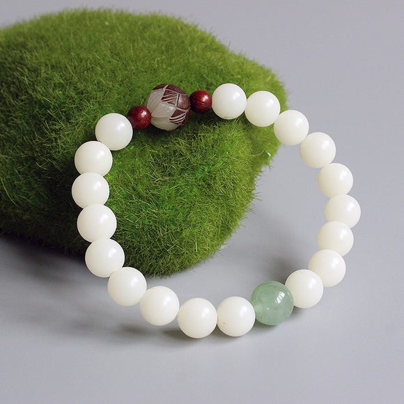 White bodhi seed bracelet with carved flower and jade accents