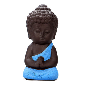 Blue Robe Meditation monk - sitting on hand
